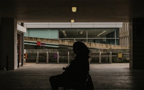 Woman on Wheelchair - dark space | © Nathan McDine on Unsplash