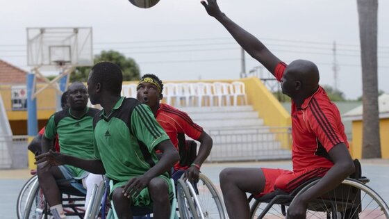 Men playing basketball on wheelchairs